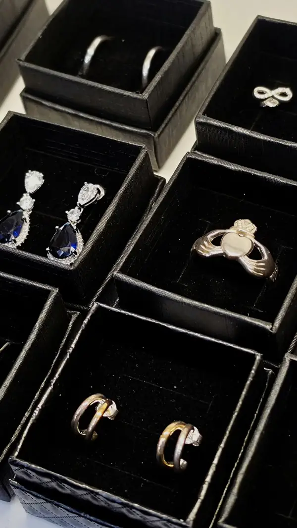 Earrings and a Claddagh ring in gift boxes