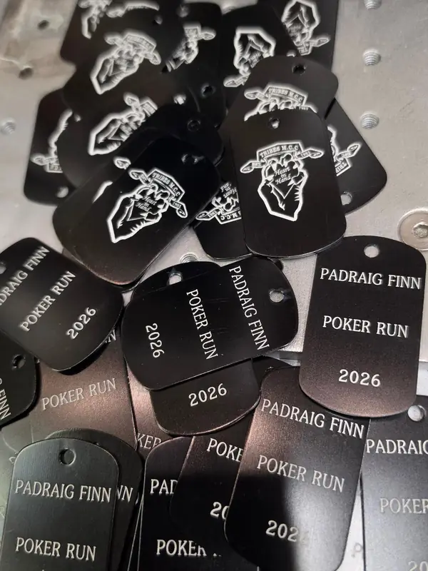 Black dog tags engraved for the Padraig Finn Poker Run 2026