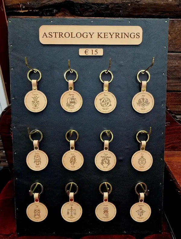Handmade astrology leather keyrings on a display board