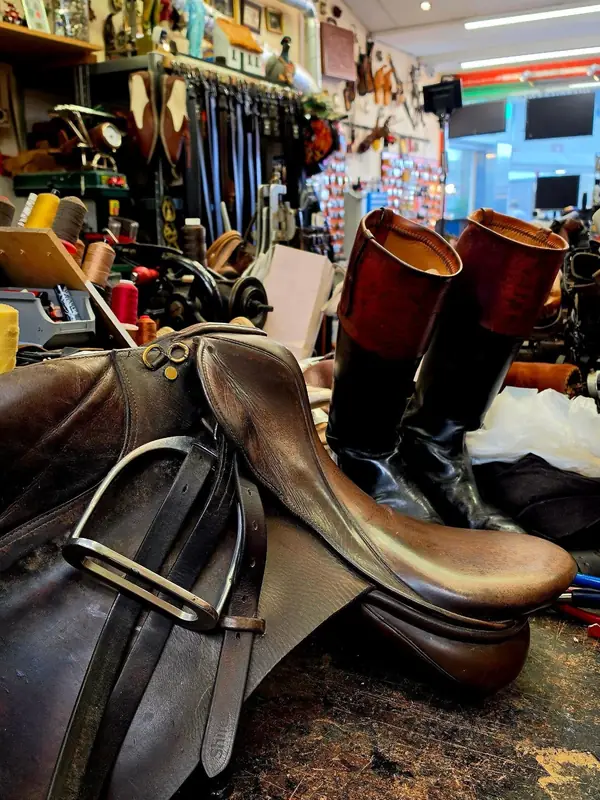 Inside the shop: a saddle, riding boots, threads and belts