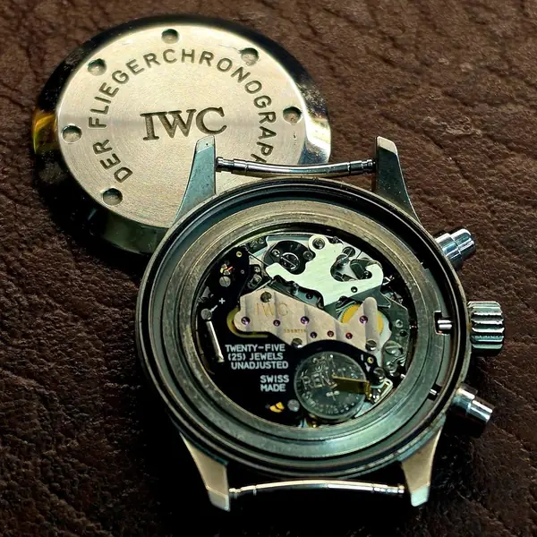 IWC quartz chronograph with its caseback off, showing the battery