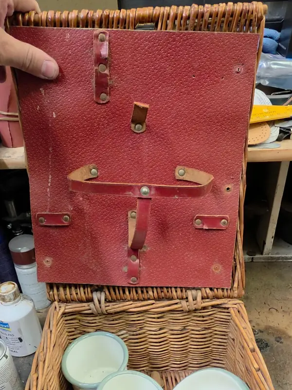 Wicker picnic hamper with its original cracked red leather panel
