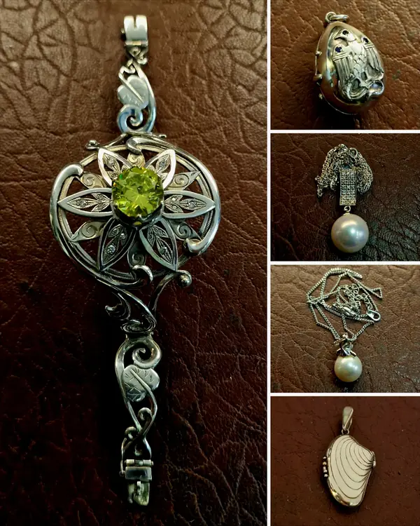 Ornate silver pendant with a green stone, and silver lockets