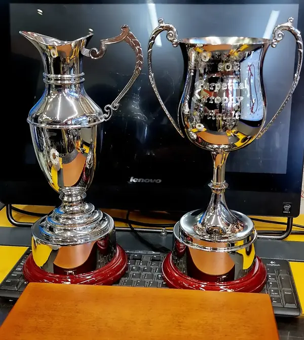 Silver trophy cups on the engraving bench