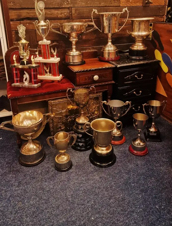 Trophy cups and shields on display in the shop